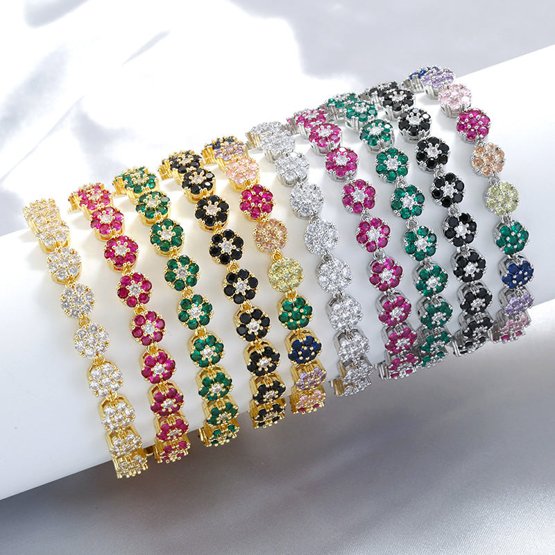 An elegant and luxurious copper bracelet, set with colored diamonds and decorated with floral and petal patterns.